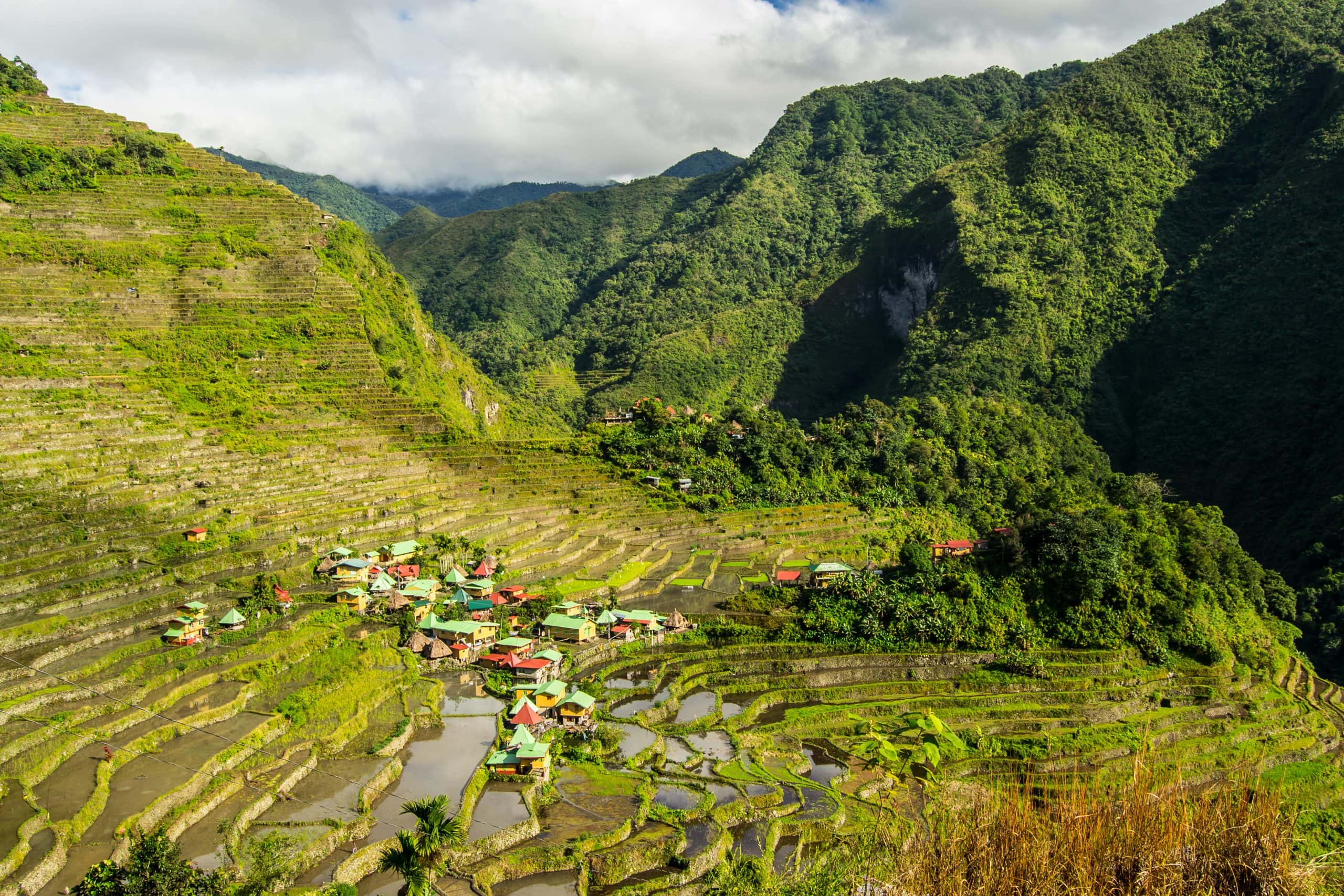 Batad Rice Terraces in Northern Luzon, Philippines, with traditional mountain villages surrounded by steep green rice fields and lush tropical mountains.