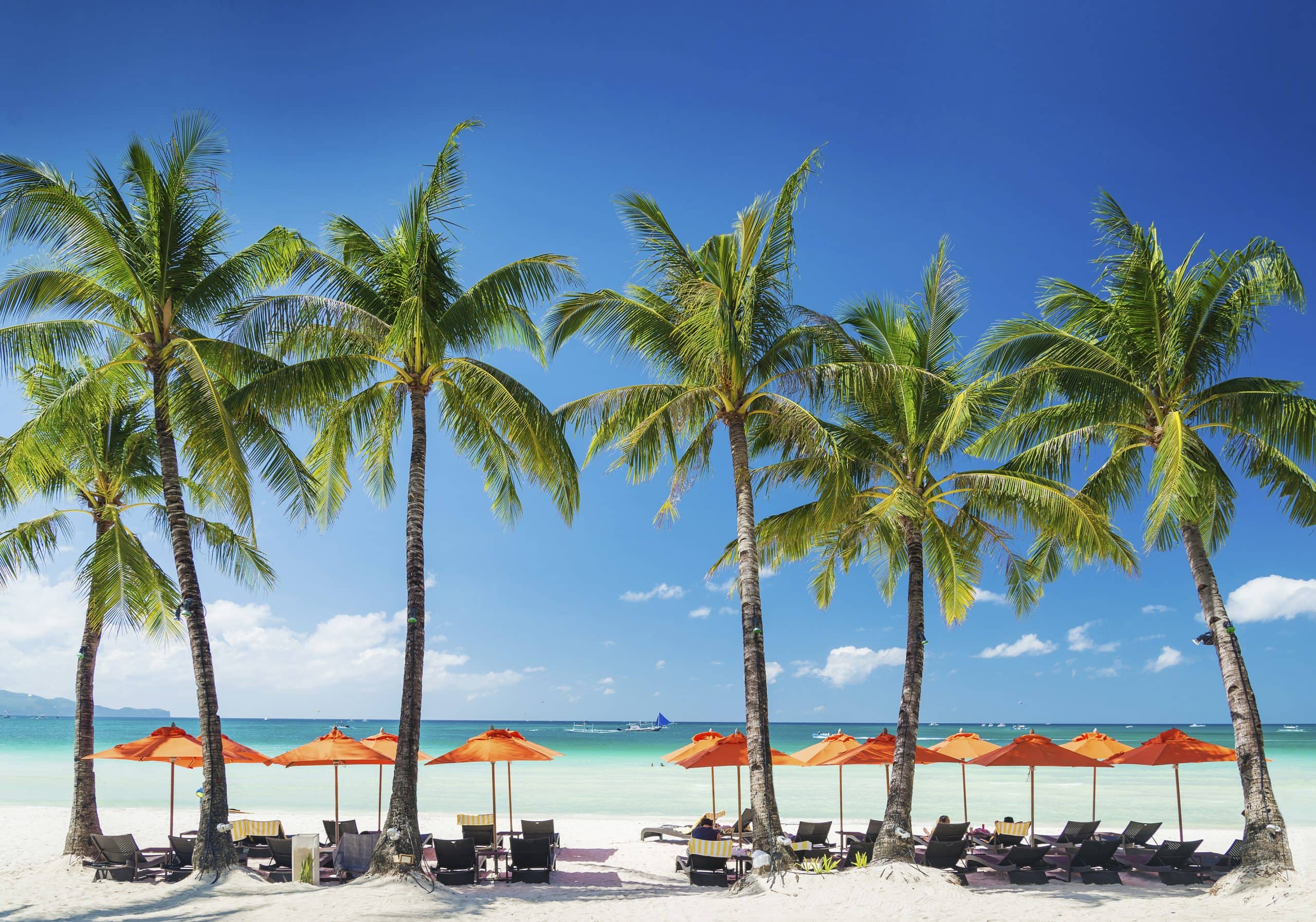 beach lounge bar loungers chairs and umbrellas on tropical exotic boracay island in philippines