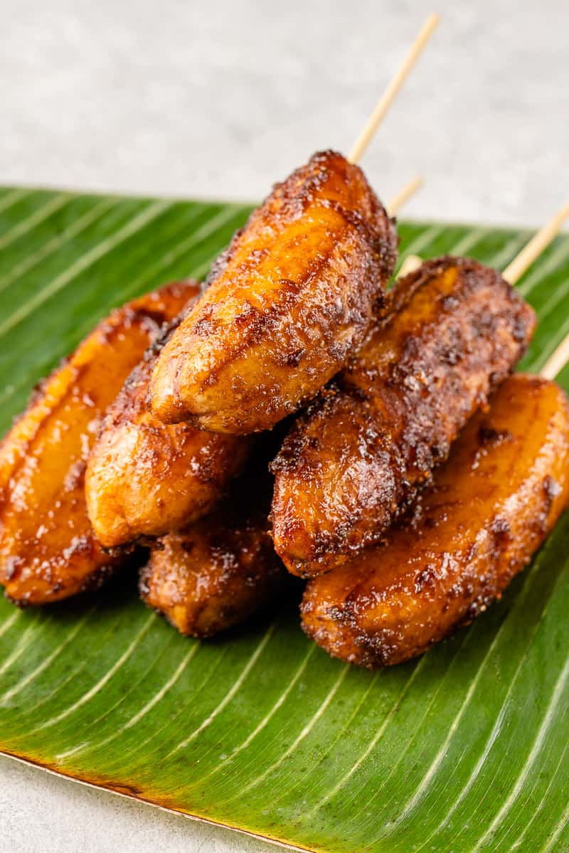 Filipino banana cue with caramelized brown sugar served on bamboo skewers.